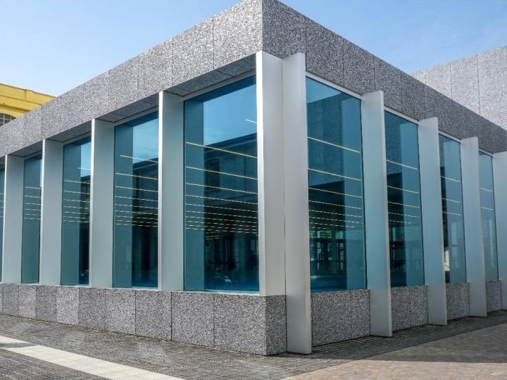 Modern commercial building with large vertical double glazing window units framed in sleek metal structures, offering enhanced insulation and a clean architectural look.