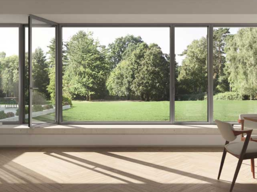 Spacious dining area with big aluminium windows offering an open view of a lush green garden and natural light.