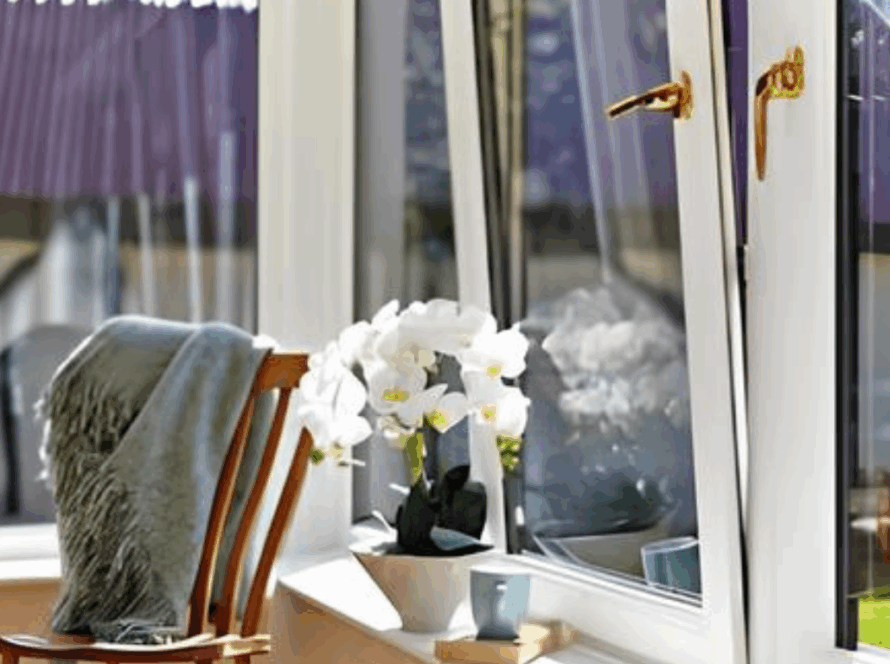 Bright modern interior with white tilt and turn windows, a wooden chair, and potted white flowers on the windowsill