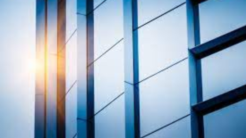 Modern building facade featuring commercial aluminium windows with reflective glass and sleek frames
