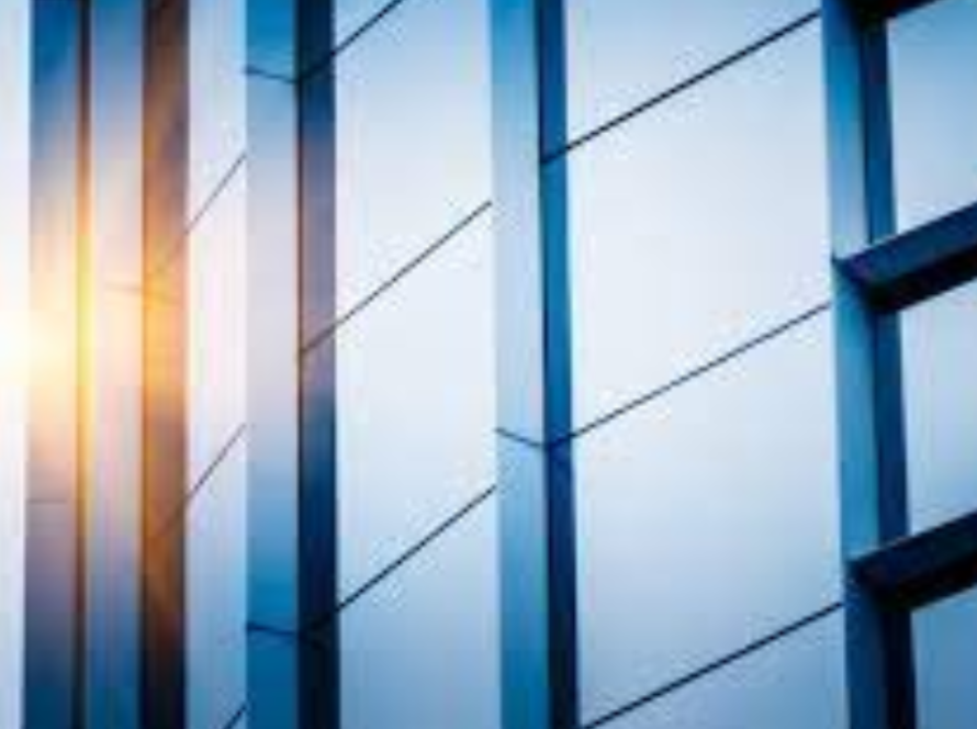 Modern building facade featuring commercial aluminium windows with reflective glass and sleek frames