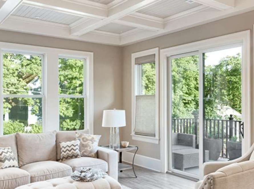 Bright living room featuring aluminum double pane windows offering clear views and natural lighting
