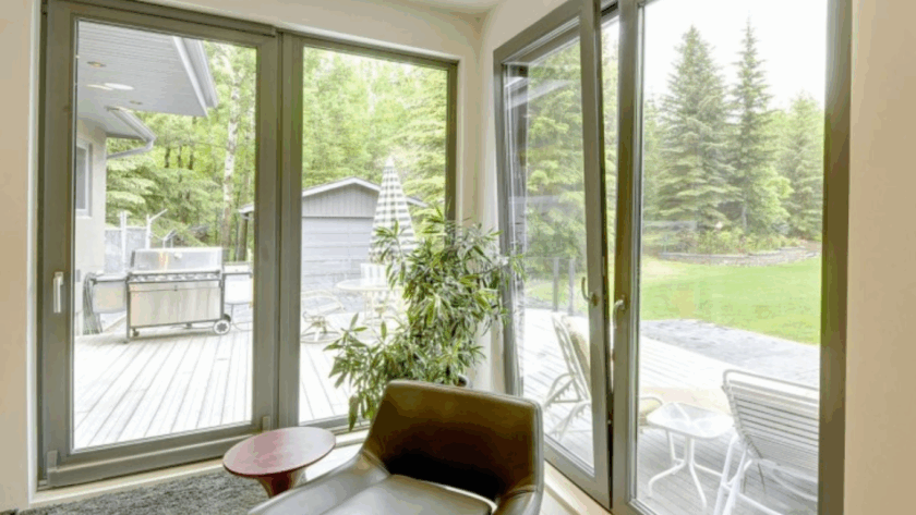 Contemporary interior with large European tilt and turn windows, offering stunning garden views, enhanced energy efficiency, and elegant modern style