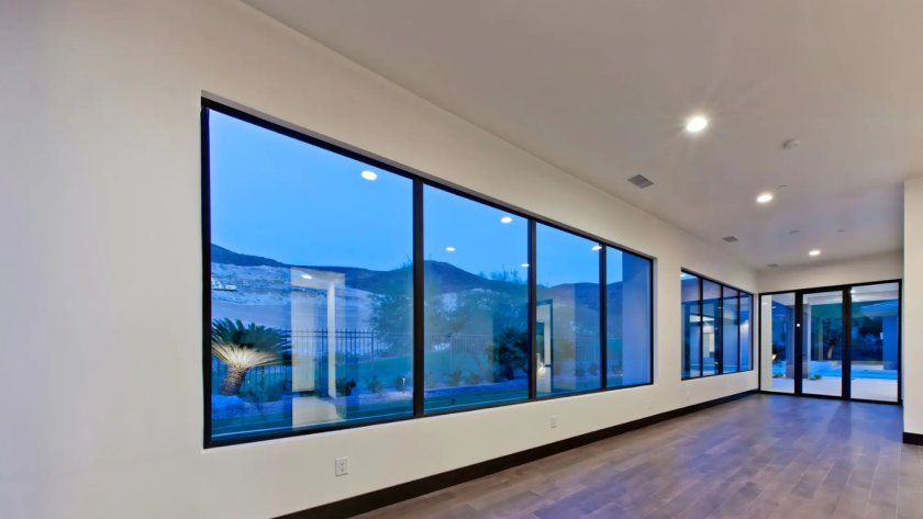 Contemporary interior featuring aluminium fixed glass windows providing panoramic outdoor views