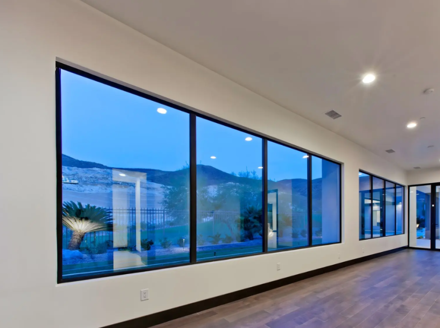 Contemporary interior featuring aluminium fixed glass windows providing panoramic outdoor views