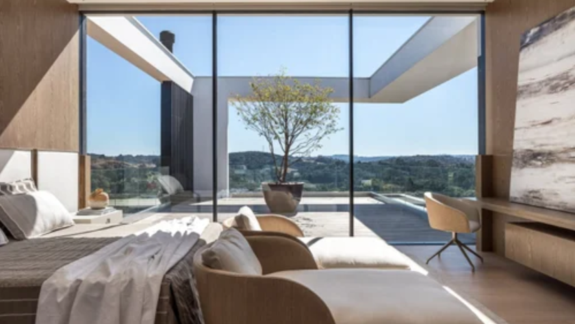 Modern interior with large fixed aluminium windows offering expansive, unobstructed outdoor views