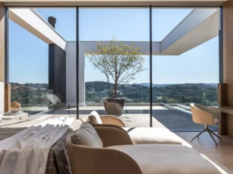 Modern interior with large fixed aluminium windows offering expansive, unobstructed outdoor views