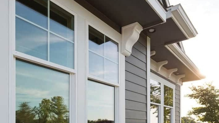 Elegant powder coated aluminium windows with white frames reflecting natural surroundings