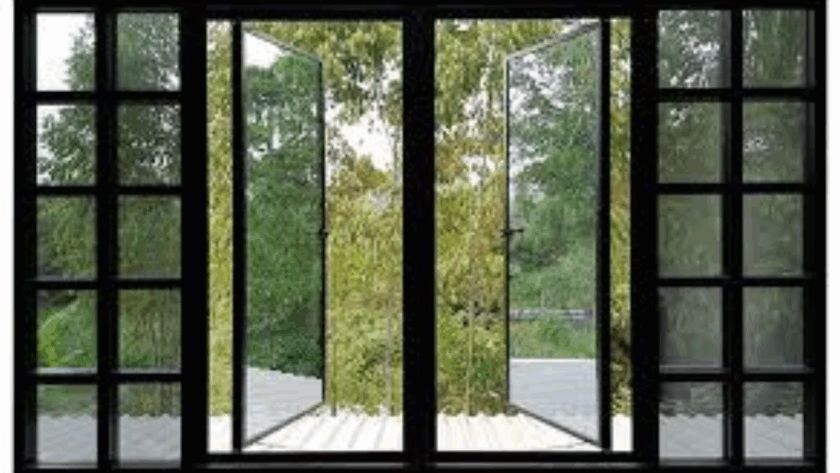Dark-framed swing and tilt windows fully opened to a lush green view, combining modern design with flexible ventilation and natural light.