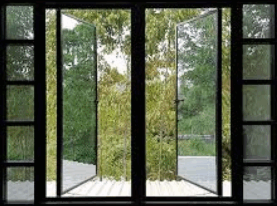 Dark-framed swing and tilt windows fully opened to a lush green view, combining modern design with flexible ventilation and natural light.