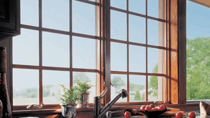 Wooden 400 series casement window with grilles, offering a clear view of the landscape and natural light into the kitchen