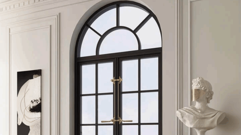 Arched casement windows with black frame and decorative brass hardware in a classic interior setting