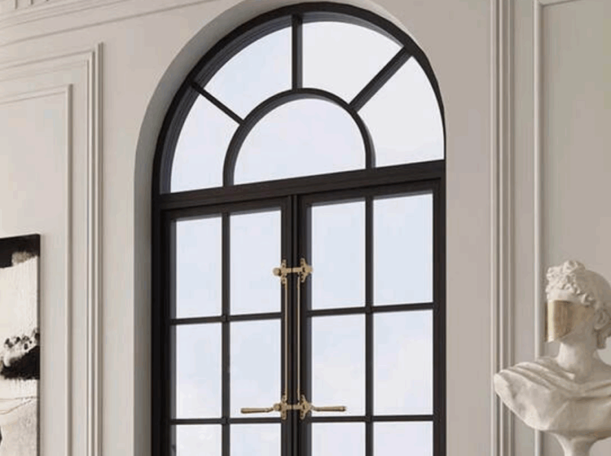 Arched casement windows with black frame and decorative brass hardware in a classic interior setting