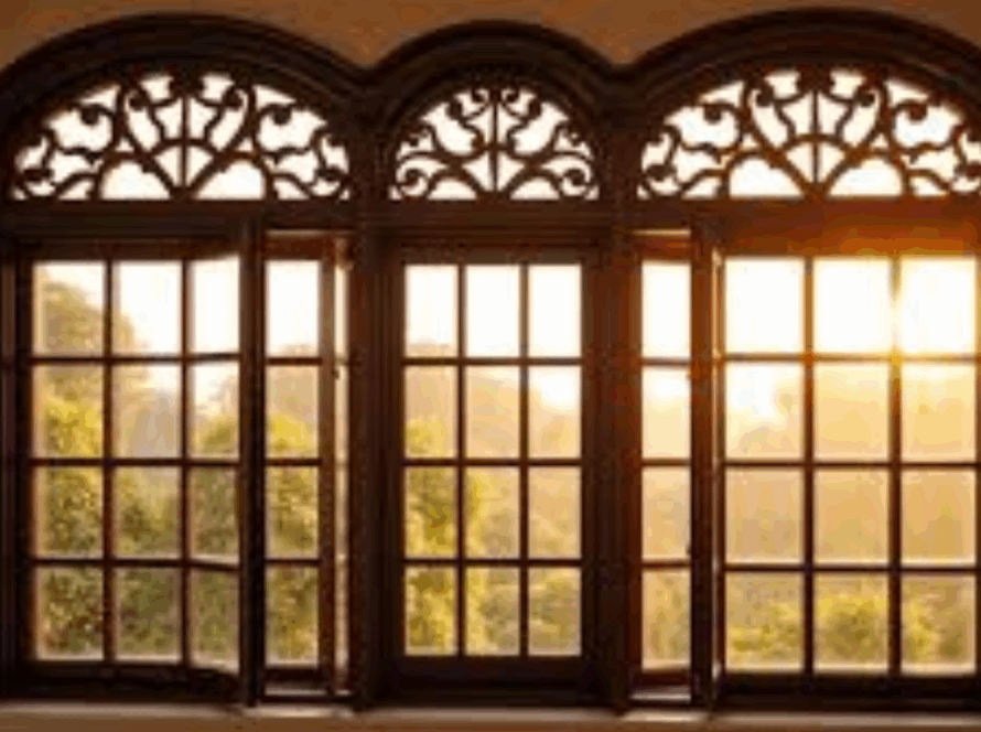 Ornate arched French windows with decorative framing, overlooking a sunlit garden