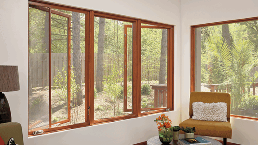 Open wooden push out casement windows offering a relaxing view of the sunny garden and lush greenery