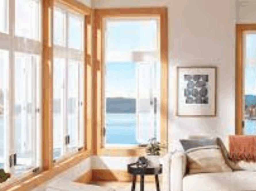 Casement windows with natural wood frames in a newly constructed living space overlooking a lake
