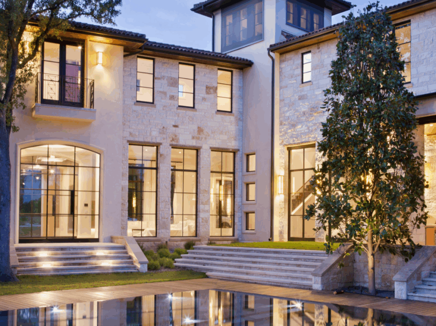 Modern exterior casement windows on a luxury stone house with large glass panels