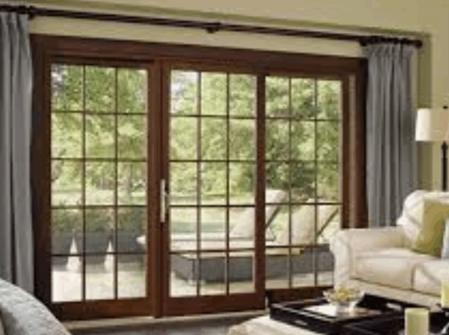 Elegant wooden French sliding windows overlooking a comfortable garden patio from a cozy living room