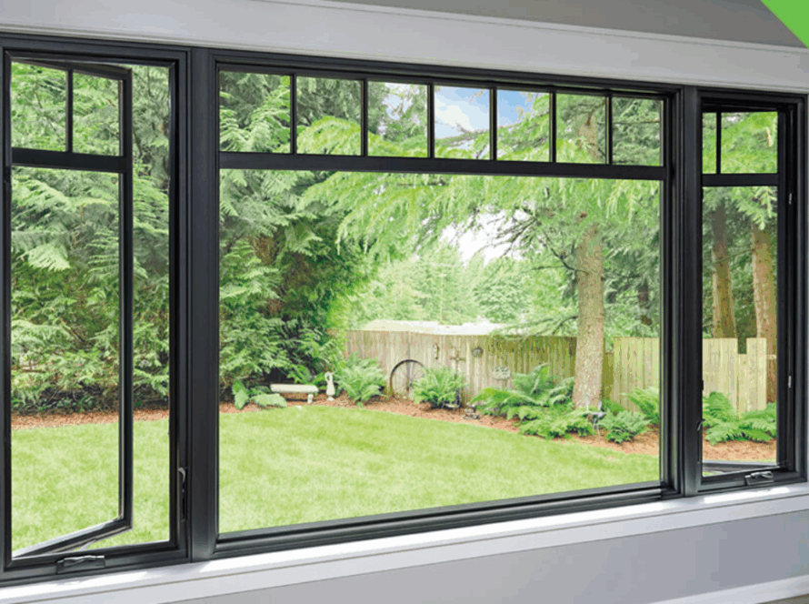 Black-framed large casement windows with side openings and top transom panels, offering a view of a green backyard with trees and a fence