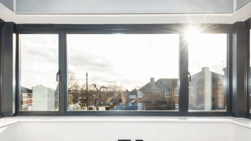 Modern side hung casement window with dark aluminum frame and outward opening panels overlooking a residential street