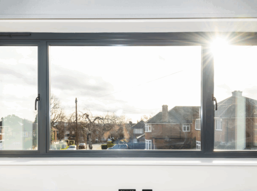 Modern side hung casement window with dark aluminum frame and outward opening panels overlooking a residential street
