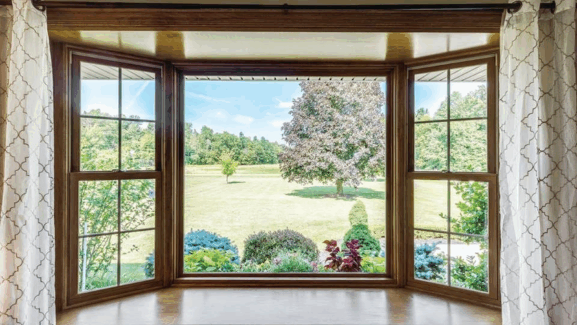 Two lite casement window with clear view and wooden frame overlooking garden