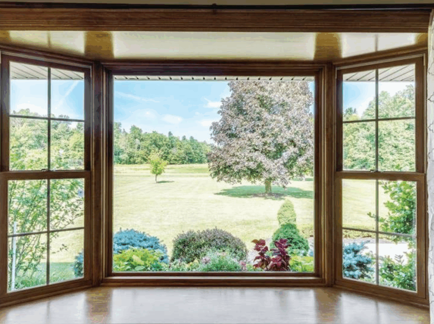 Two lite casement window with clear view and wooden frame overlooking garden