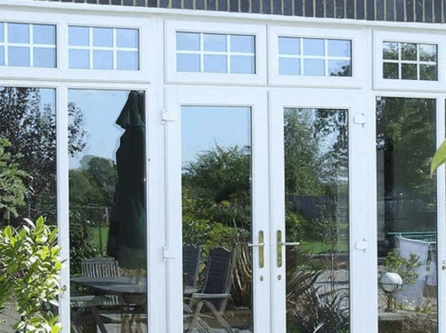 Classic white uPVC French-style windows opening to a green garden patio