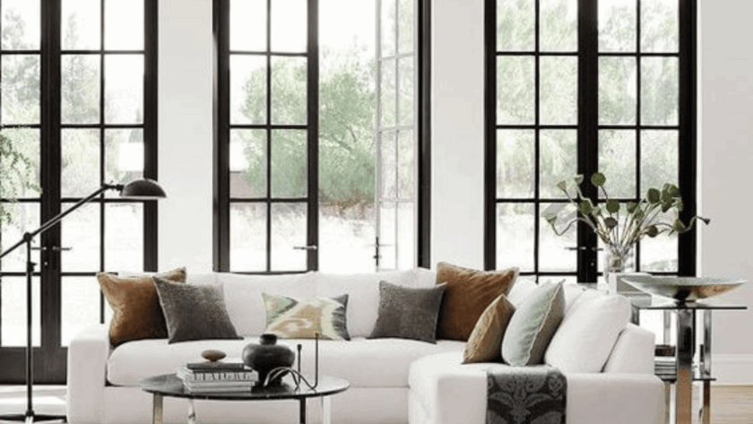 Stylish living room showcasing professionally installed casement windows overlooking a lush garden