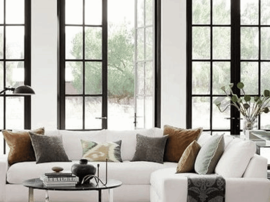 Stylish living room showcasing professionally installed casement windows overlooking a lush garden