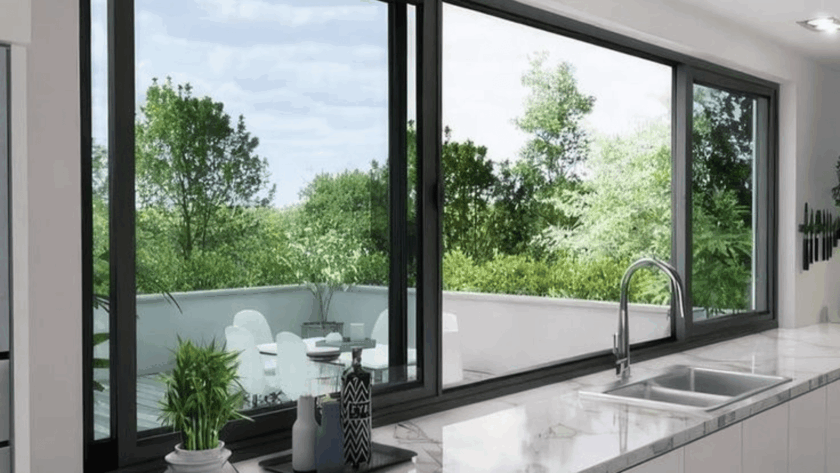Modern kitchen featuring double pane sliding windows with a lush outdoor view