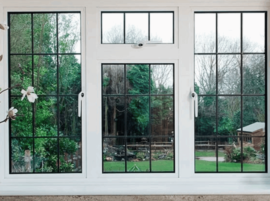 White interior casement windows overlooking a lush backyard garden