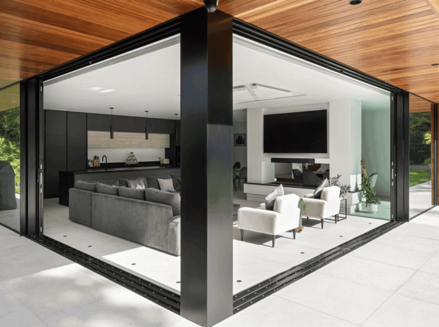 Spacious living area featuring modern powder coated sliding windows opening to an outdoor patio
