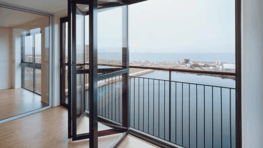 Balcony featuring modern aluminium sliding windows overlooking a waterfront view