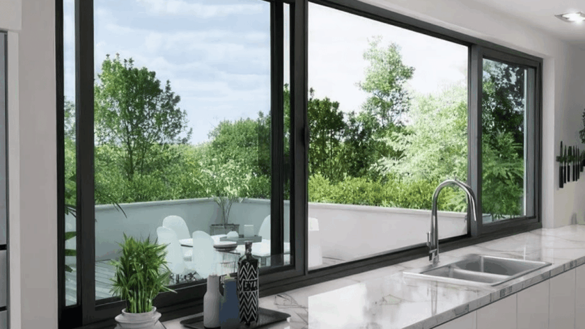 Contemporary kitchen interior with elegant side sliding windows overlooking a vibrant green outdoor terrace