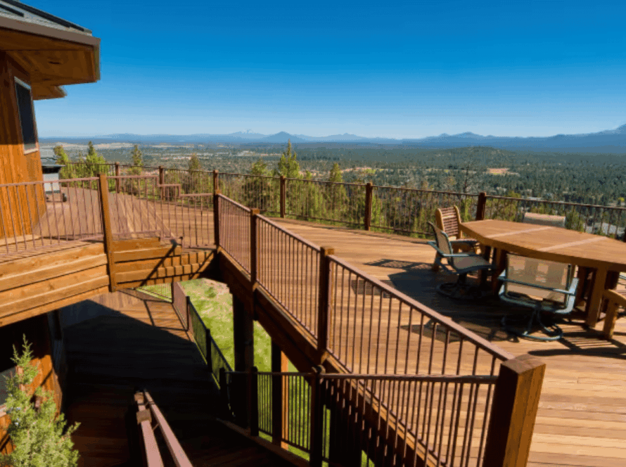 Thermo pine decking on a multi-level outdoor terrace with railings and seating, overlooking a natural landscape.