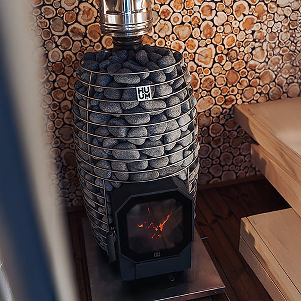 HUUM HIVE Flow wood-burning sauna stove with glass door in a sauna
