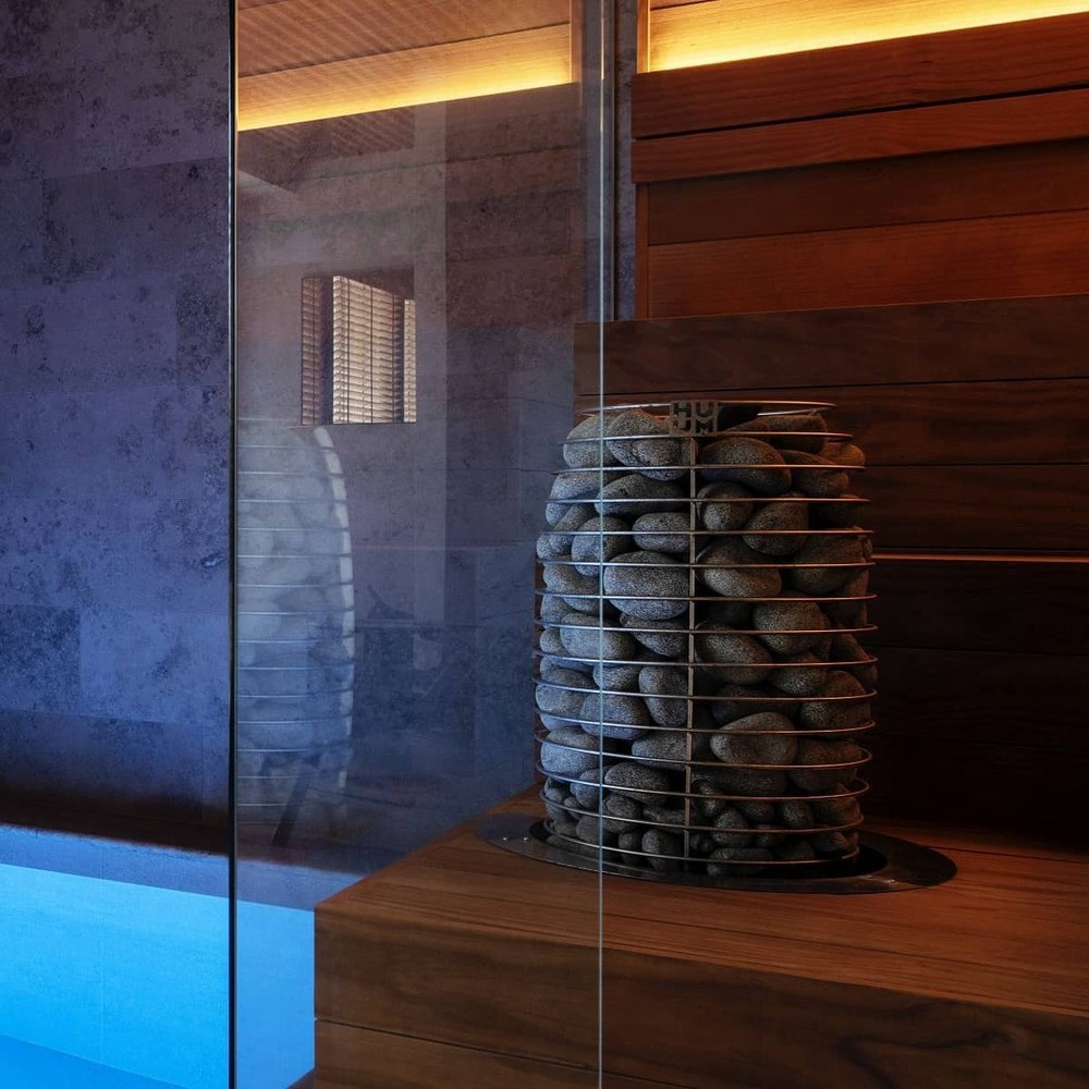 HUUM HIVE Mini electric sauna heater installed in a wood-lined sauna room