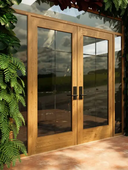 Double-panel wooden french doors with large glass inserts, surrounded by lush greenery, opening to a scenic outdoor view.
