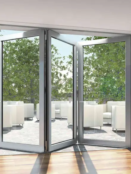 Modern accordion windows and doors with silver aluminum frames opening to an outdoor lounge area with white seating.