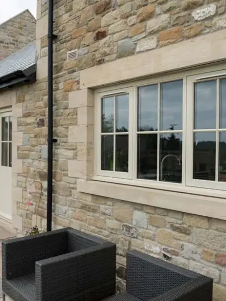 efficiency-with-elegance Flush Casement Windows installed in a traditional stone house, offering a timeless and elegant aesthetic.