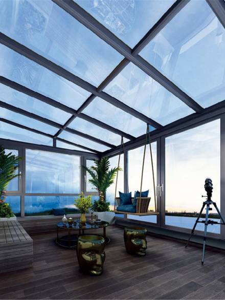 Modern glass room with panoramic aluminium windows and roof, offering stunning views and abundant natural light
