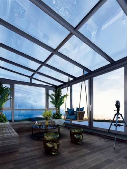 Modern glass room with panoramic aluminium windows and roof, offering stunning views and abundant natural light
